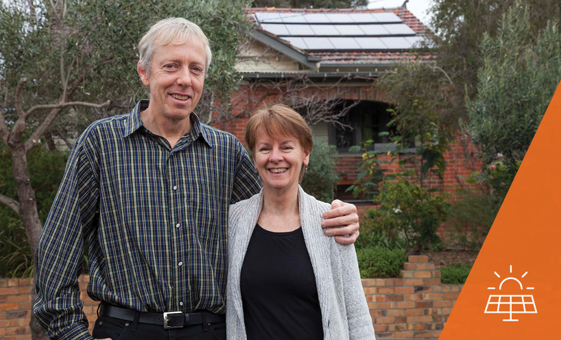 Couple standing in front of house