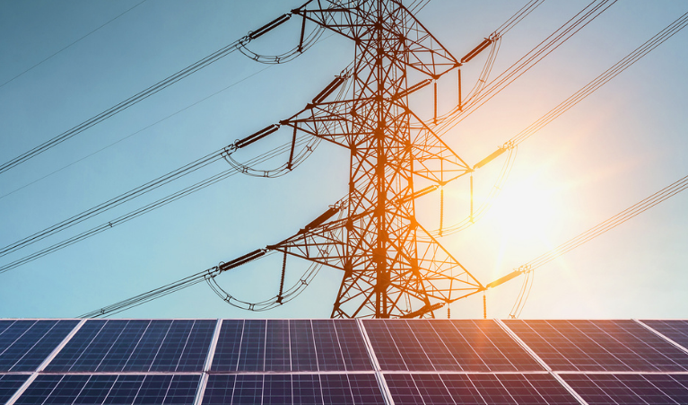 Solar panels with power lines in the background