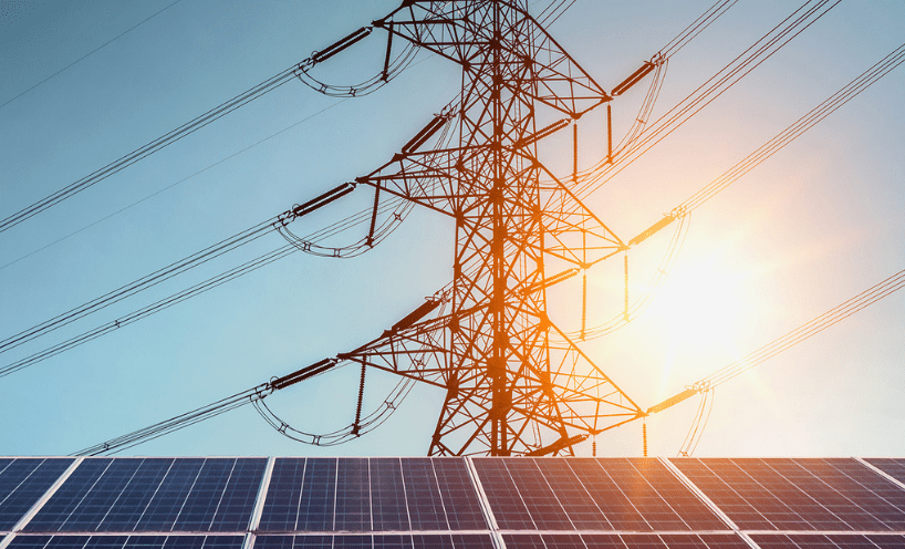 Solar panels with power lines in the background