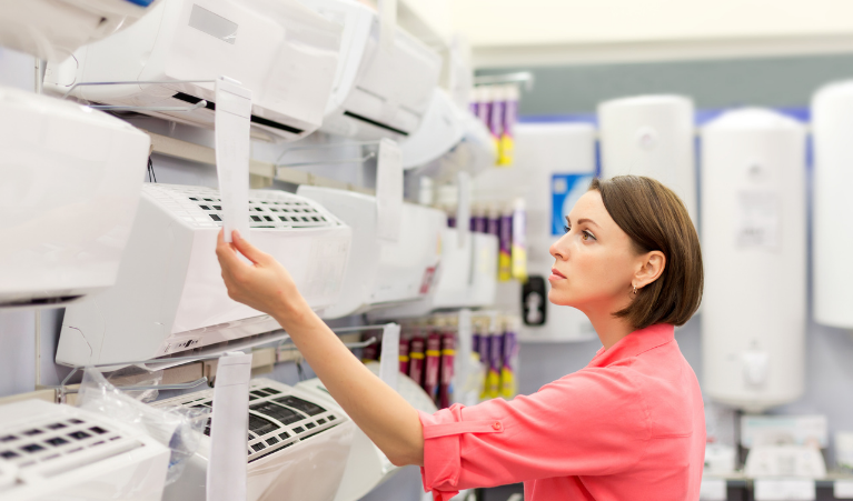 Woman in te shop looking at air conditioners