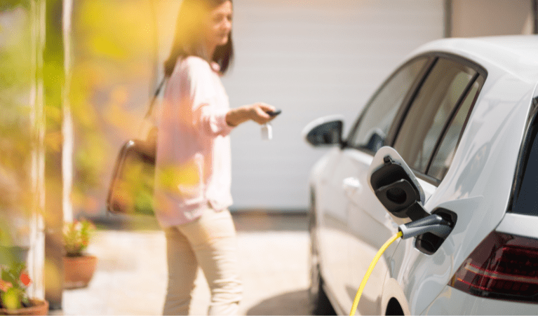 a lady is locking her electric vehicle